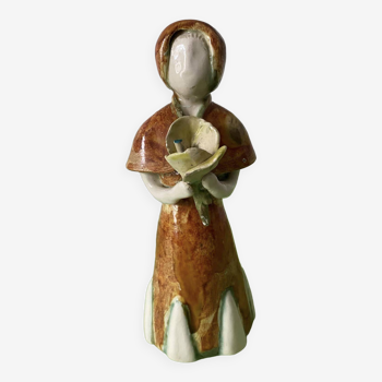 Glazed ceramic representing a woman carrying a bouquet. Handmade