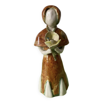 Glazed ceramic representing a woman carrying a bouquet. Handmade