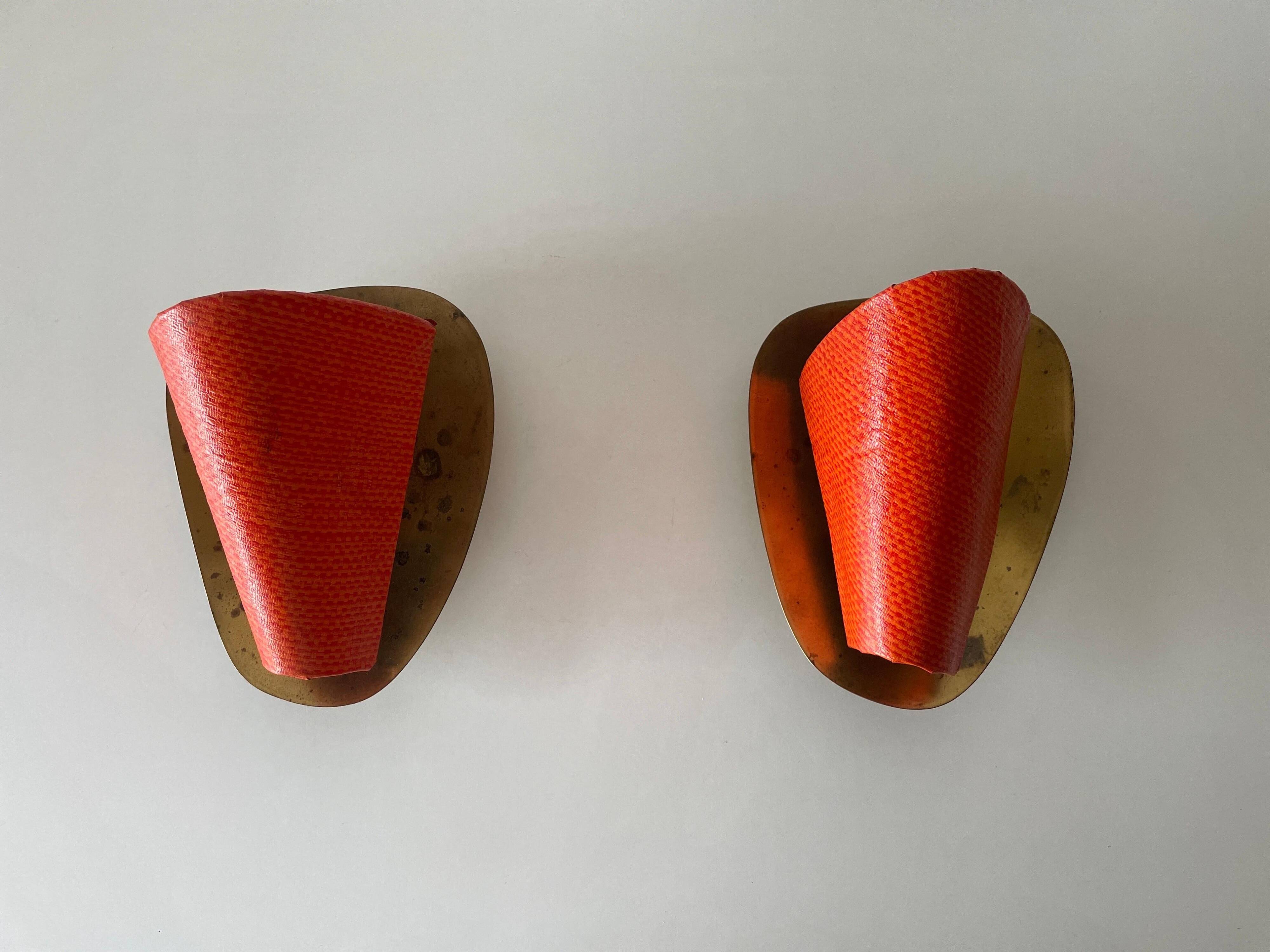 Pair of orange plexiglass and curved brass wall lights, 1950s, Germany