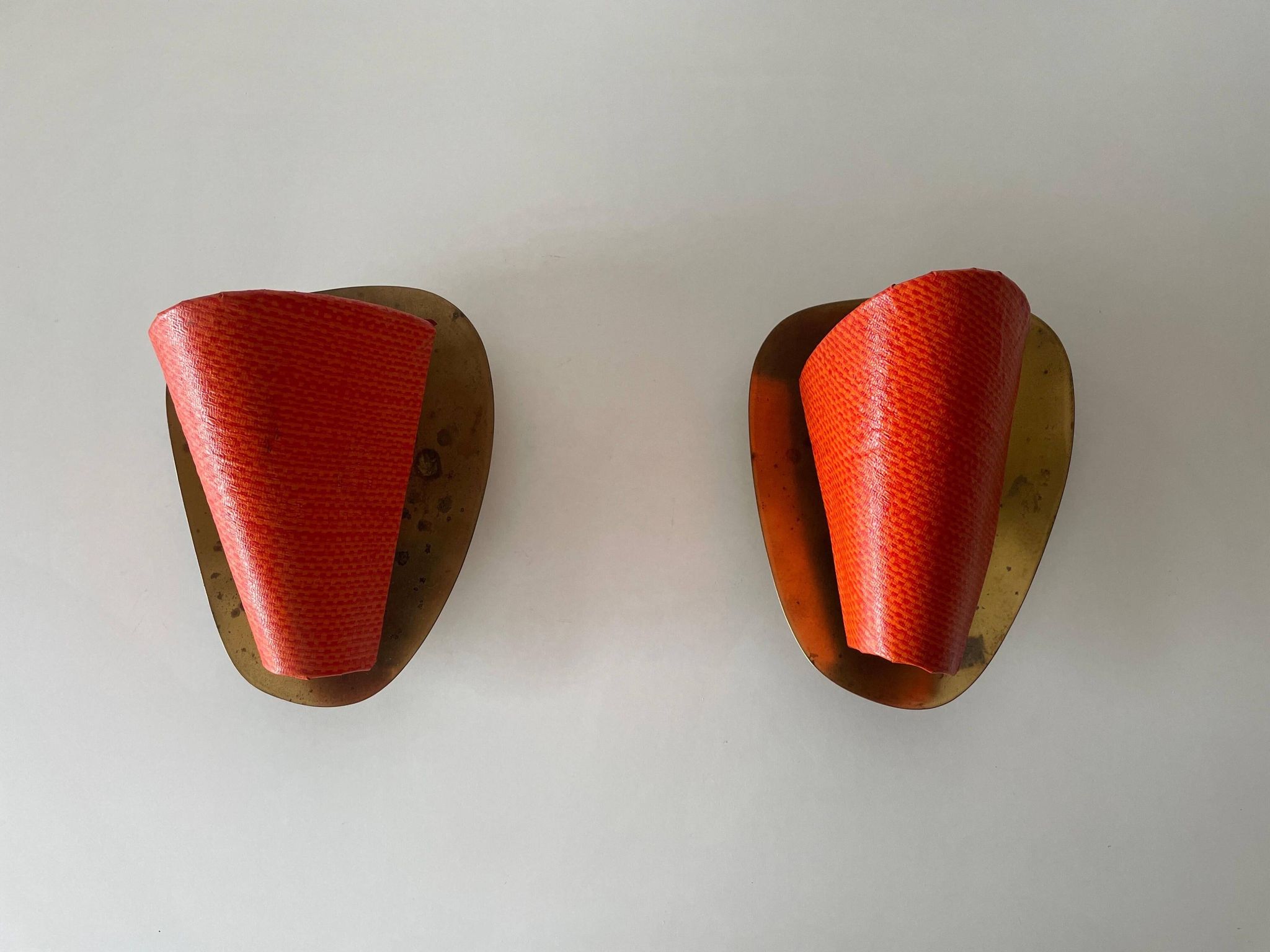 Pair of orange plexiglass and curved brass wall lights, 1950s, Germany