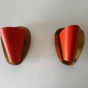 Pair of orange plexiglass and curved brass wall lights, 1950s, Germany