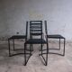 Set of 4 minimalist black steel dining chairs.