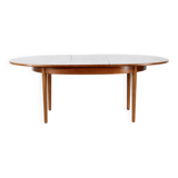 A stylish vintage teak danish influenced extending dining table for sale.  Supported on four slender