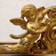 Antique mirror with a gilded frame and cherubs.