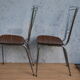Pair of formica chairs with chrome metal backs in the shape of a lyre.