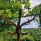 dark-coloured wooden coat rack parrot