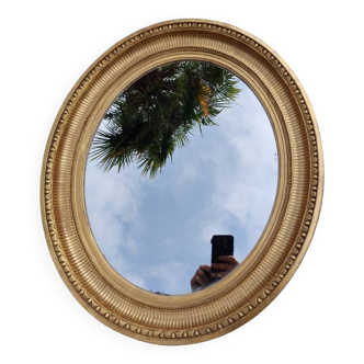 Antique oval mirror in gilded stucco with gold leaf, 19th century