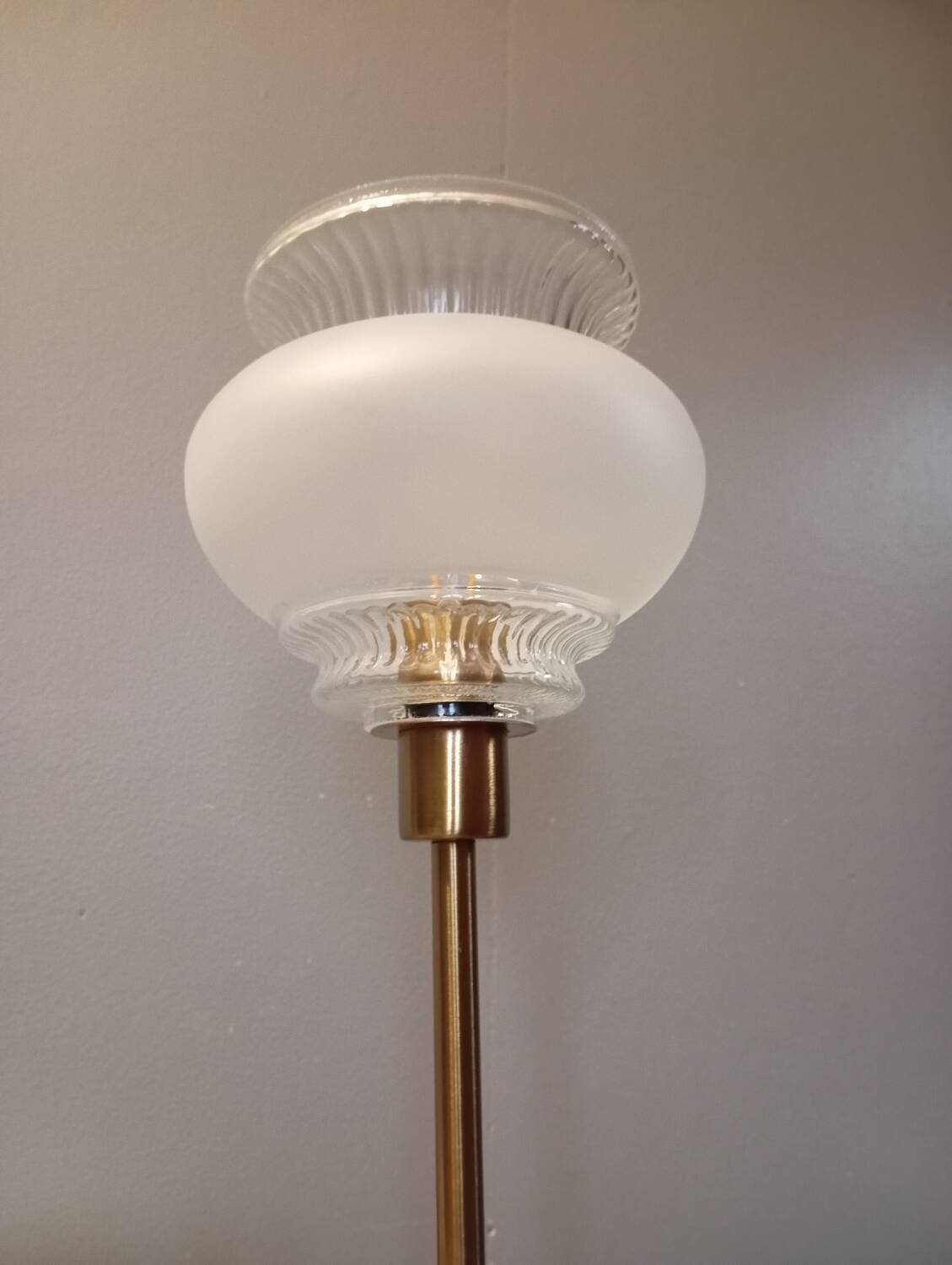 Table lamp with gold metal base and vintage white glass lampshade