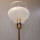 Table lamp with gold metal base and vintage white glass lampshade