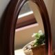 Round vintage mirror with mahogany wood effect frame.