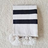 Hand-woven plaid with black stripes and white pompoms