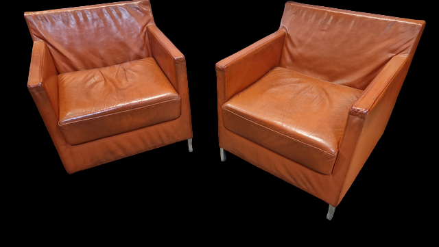 Pair of vintage orange leather armchairs