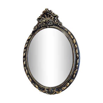 Old black and gold patinated oval mirror louis xv style