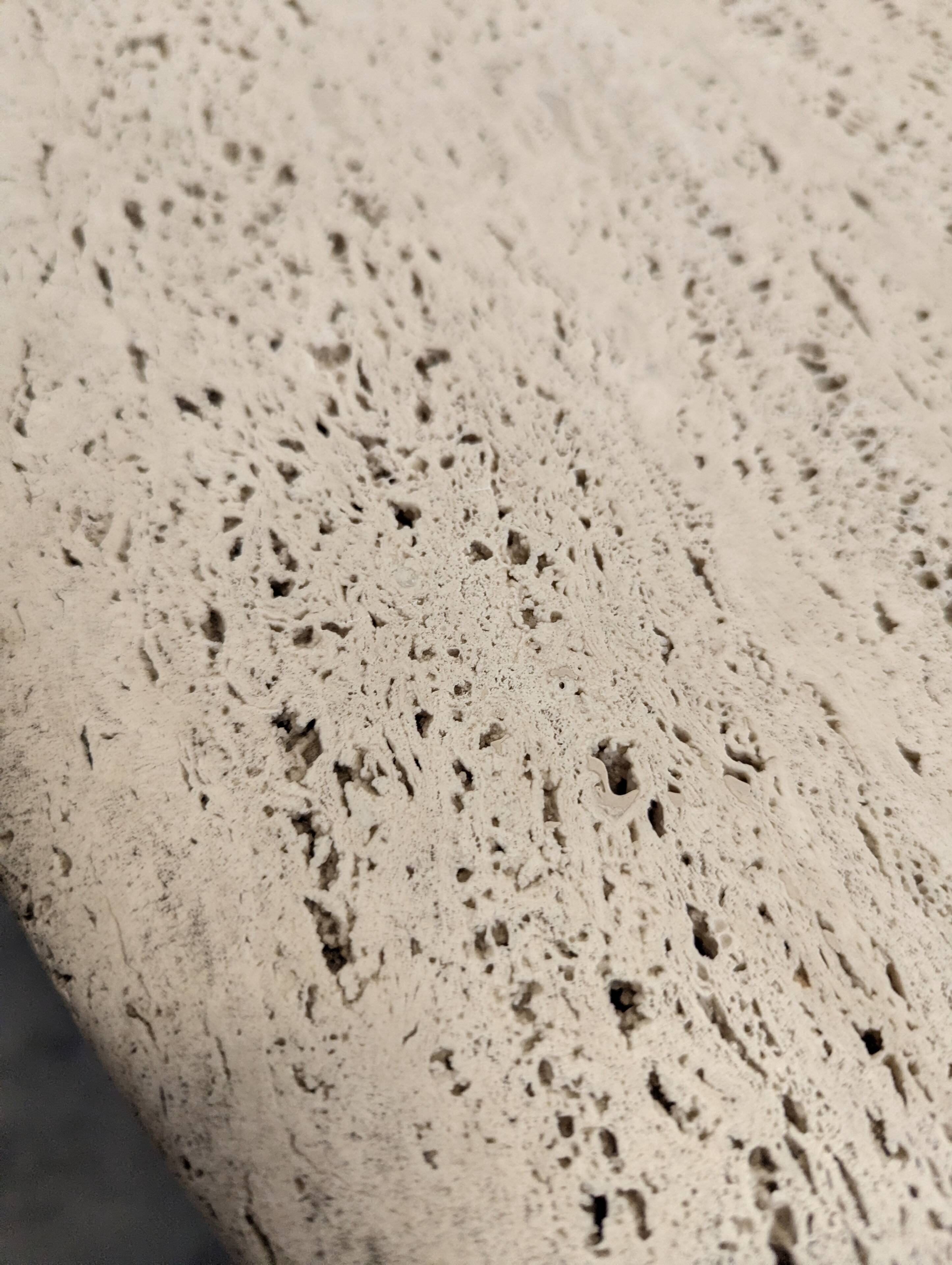 Italian dining table with a travertine top.