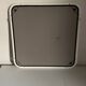 White tubular metal wall mirror