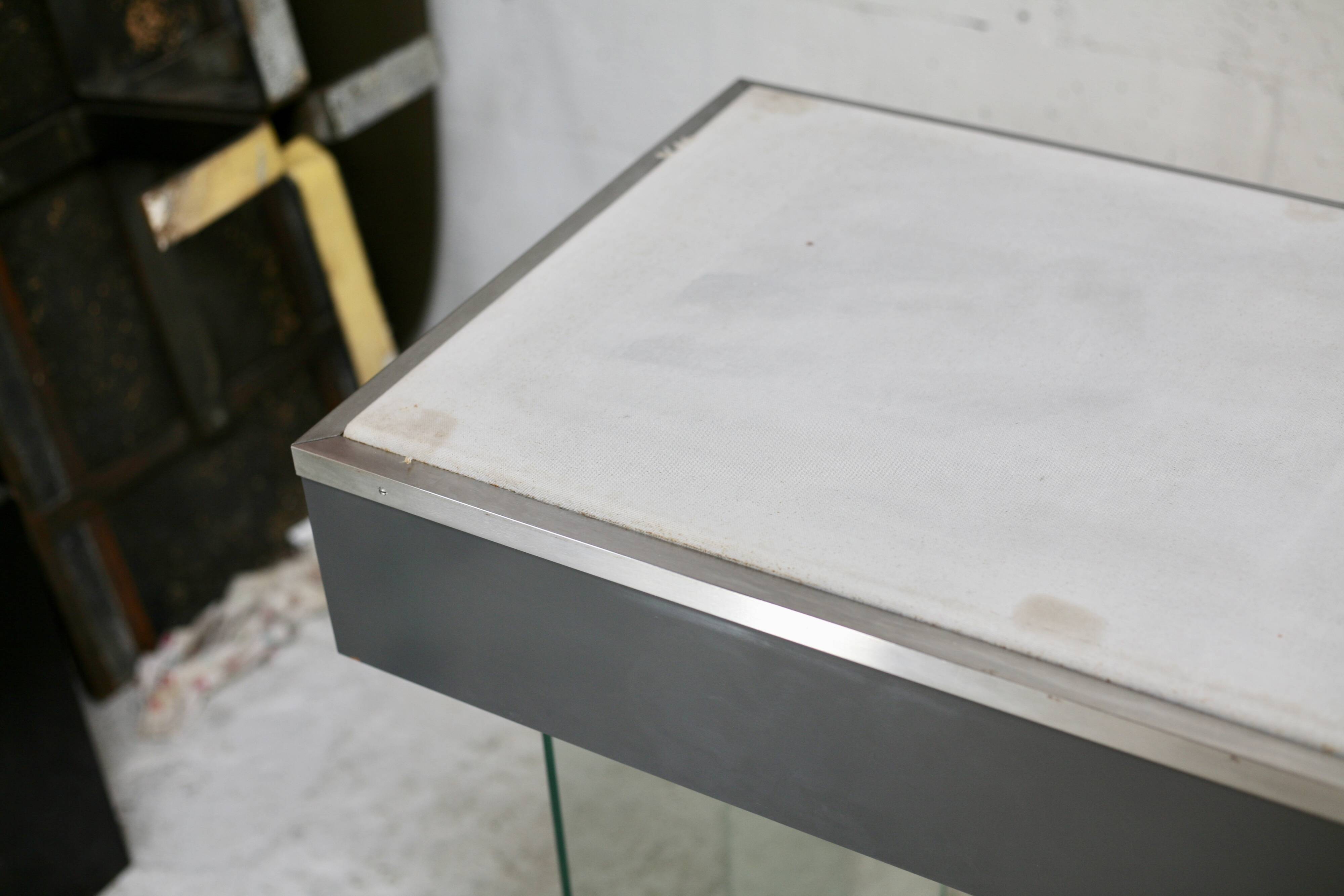 Modernist console, 1960s, glass base, wooden and fabric top.