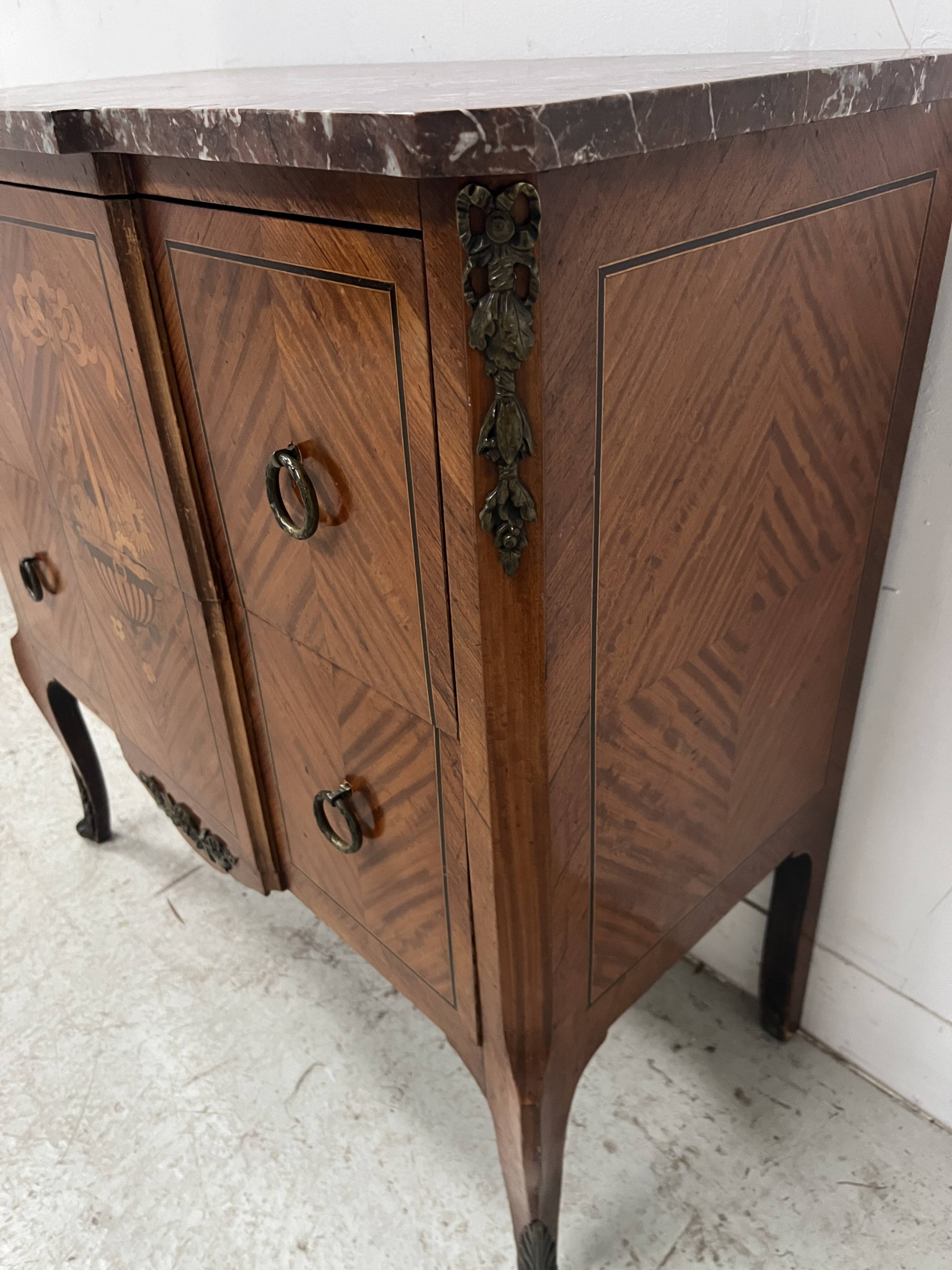 Transitional style commode with a protruding front, in marquetry wood, 20th century.