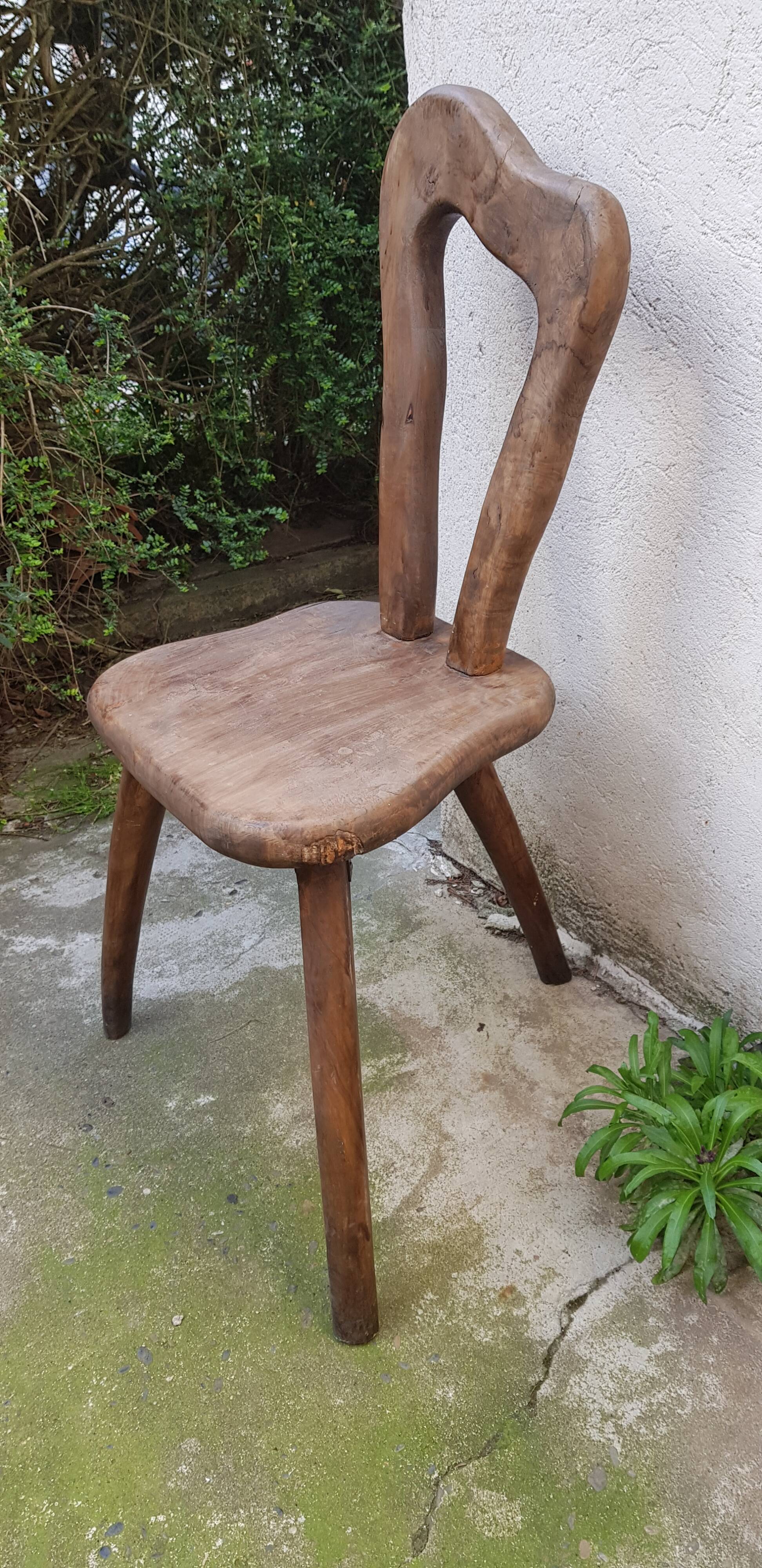 3 brutalist wooden tripod chairs