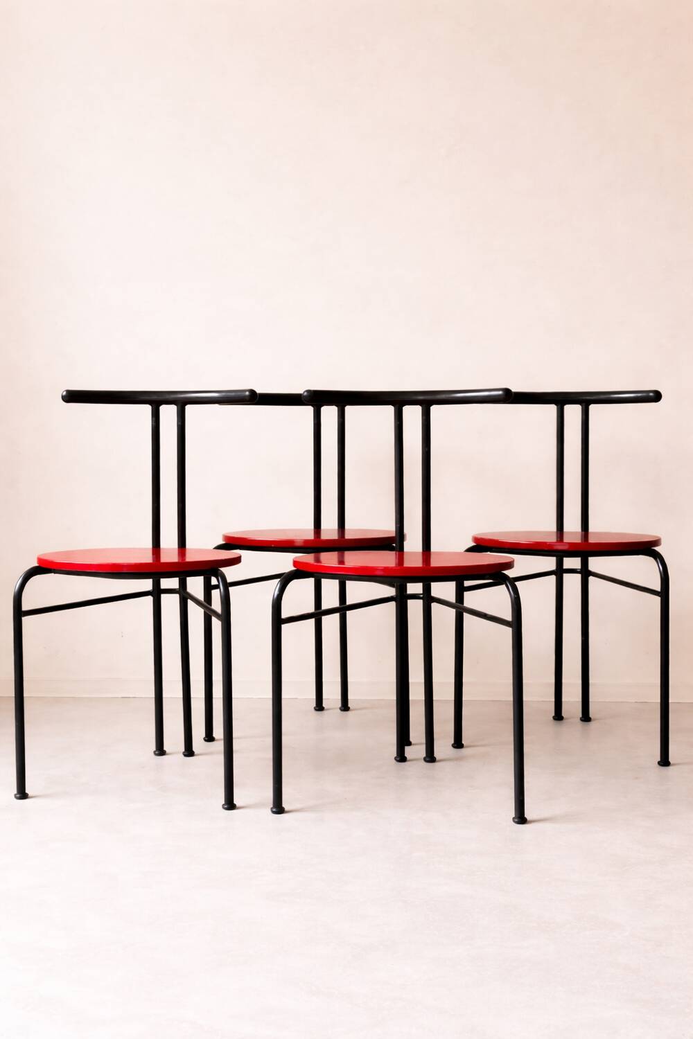 Set of 4 vintage black metal chairs with red lacquered seats.