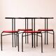 Set of 4 vintage black metal chairs with red lacquered seats.