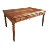 Antique French walnut table with six drawers, parquet top, early 20th century.