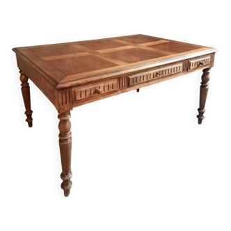 Antique French walnut table with six drawers, parquet top, early 20th century.