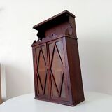 Small antique wall cabinet in Gothic style.