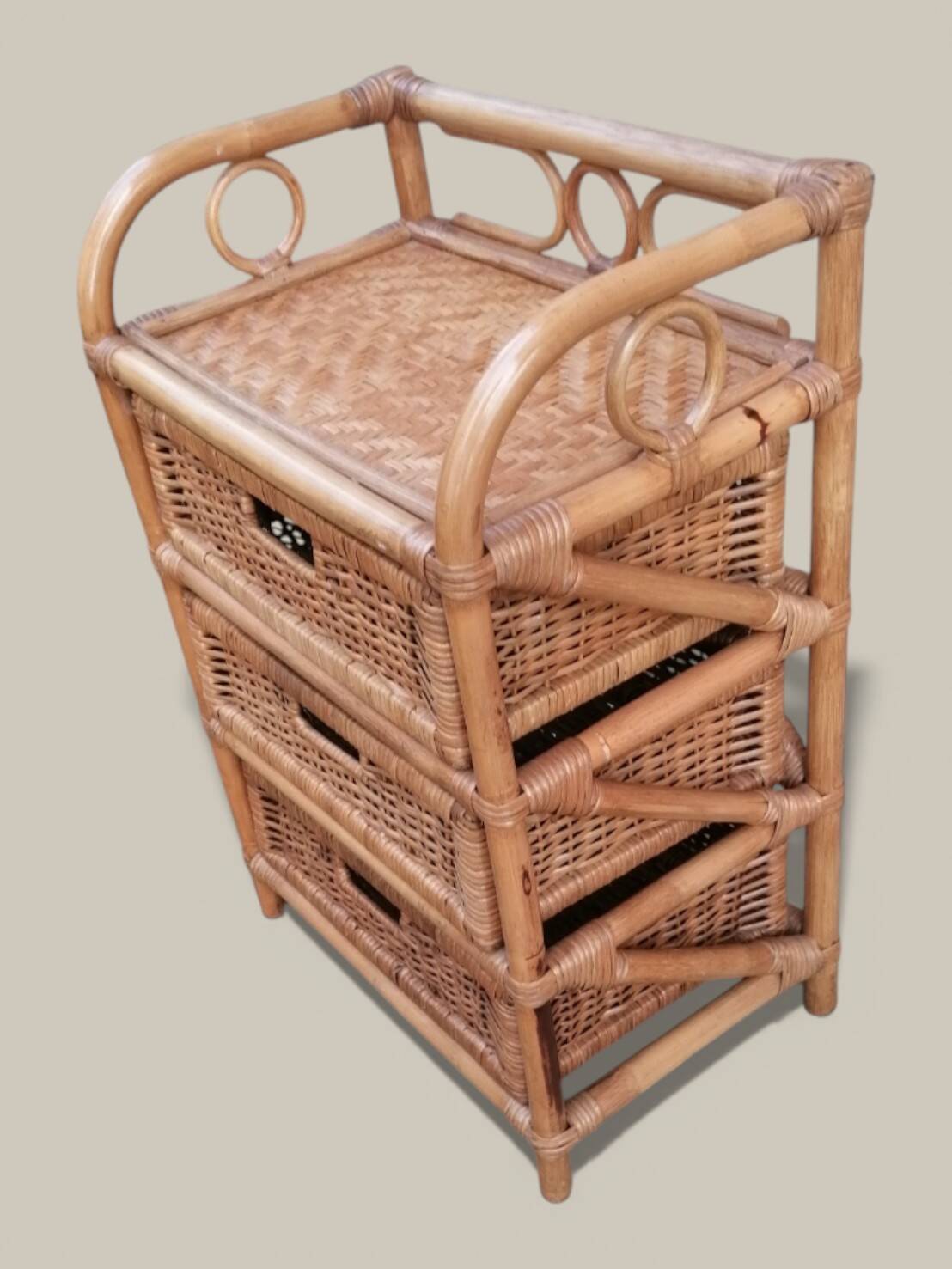 Small storage unit / freestanding shelf in light rattan.