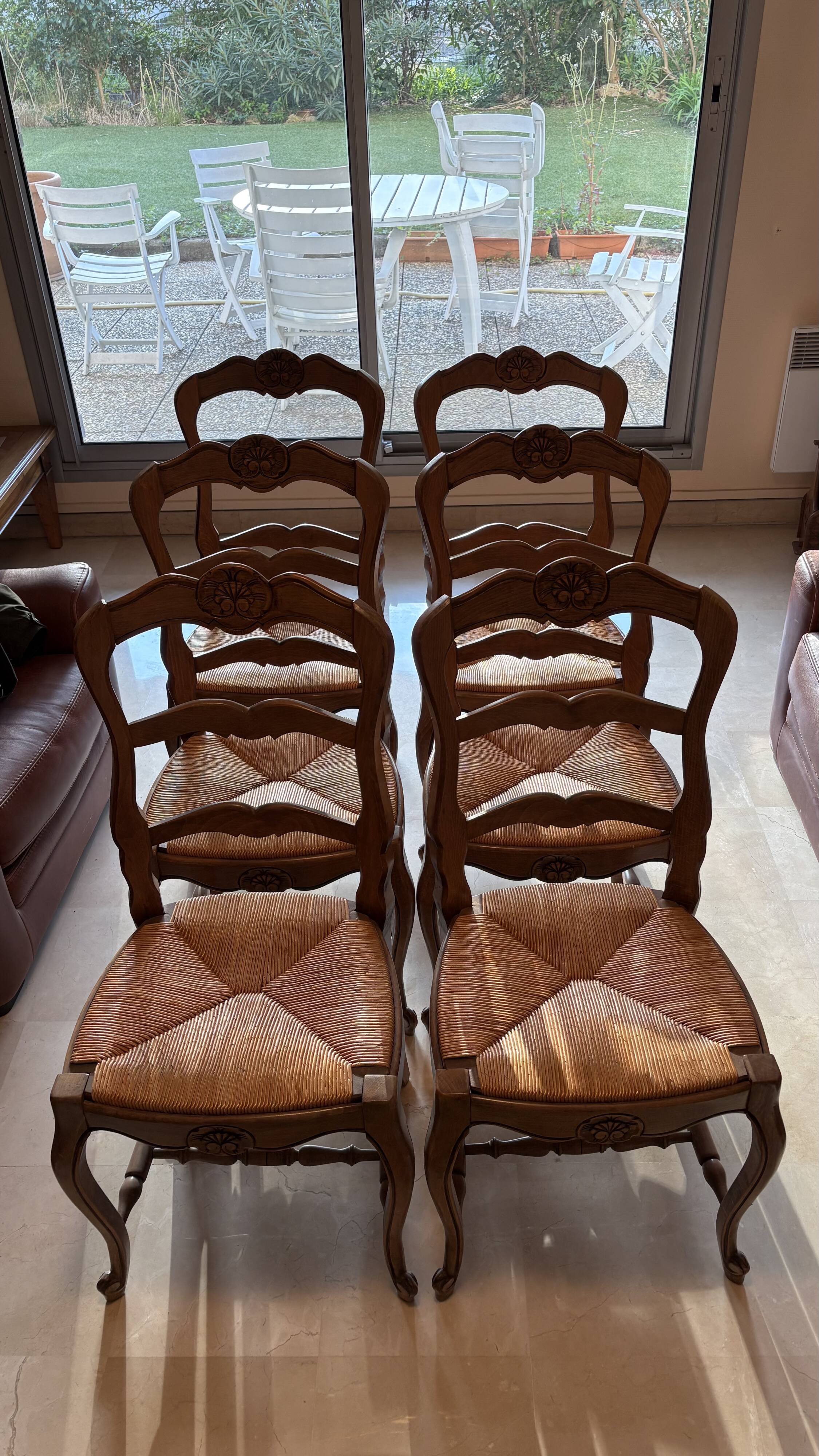 Set of 6 wooden chairs with straw seats.