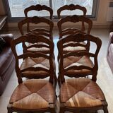 Set of 6 wooden chairs with straw seats.