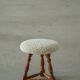 Modern Danish stool, with three oak legs featuring turned feet and a lambswool seat, 1950s.