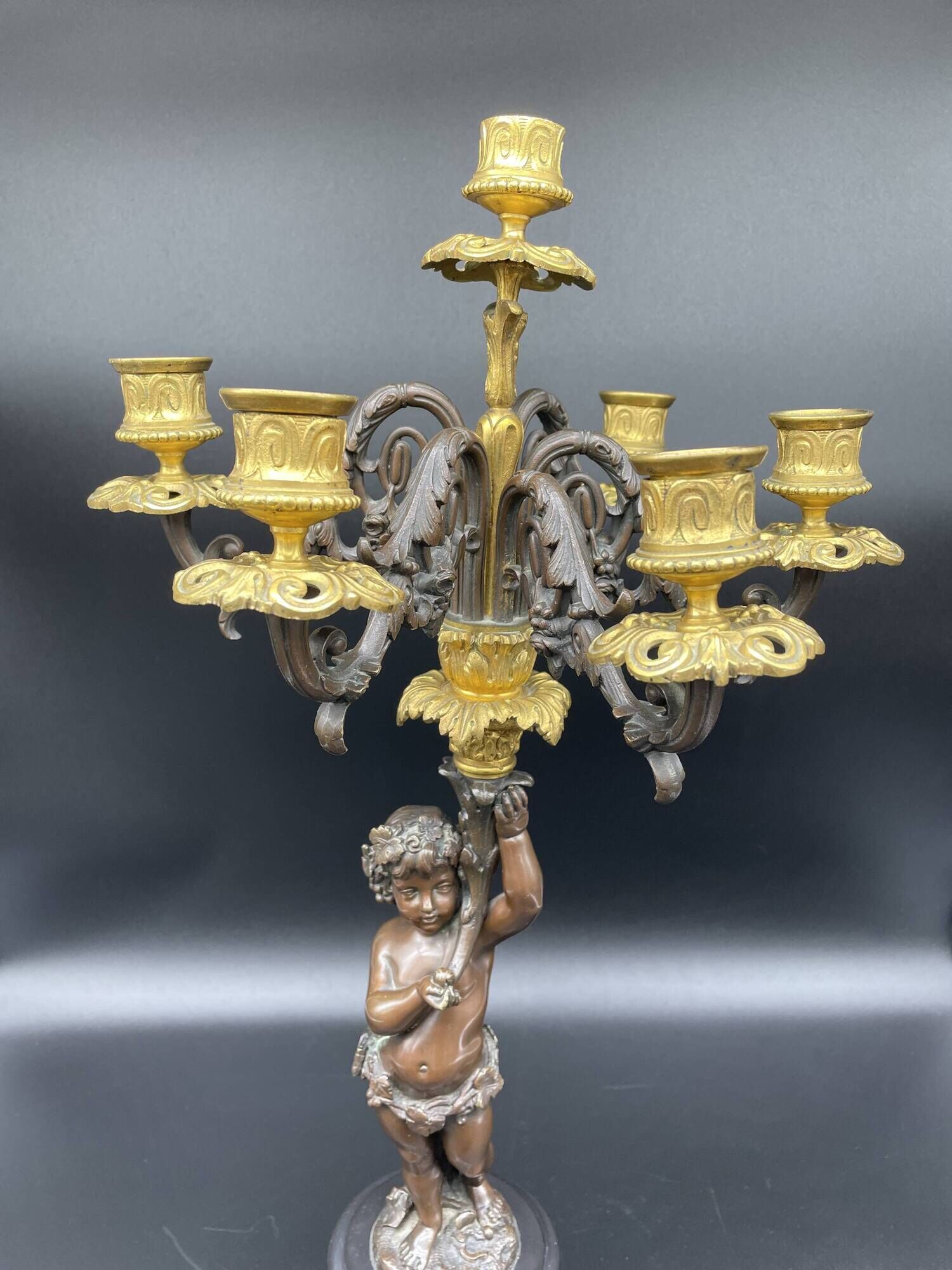 Candelabra with cherub in patinated bronze