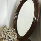 Old oval mirror with wooden frame