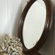 Old oval mirror with wooden frame