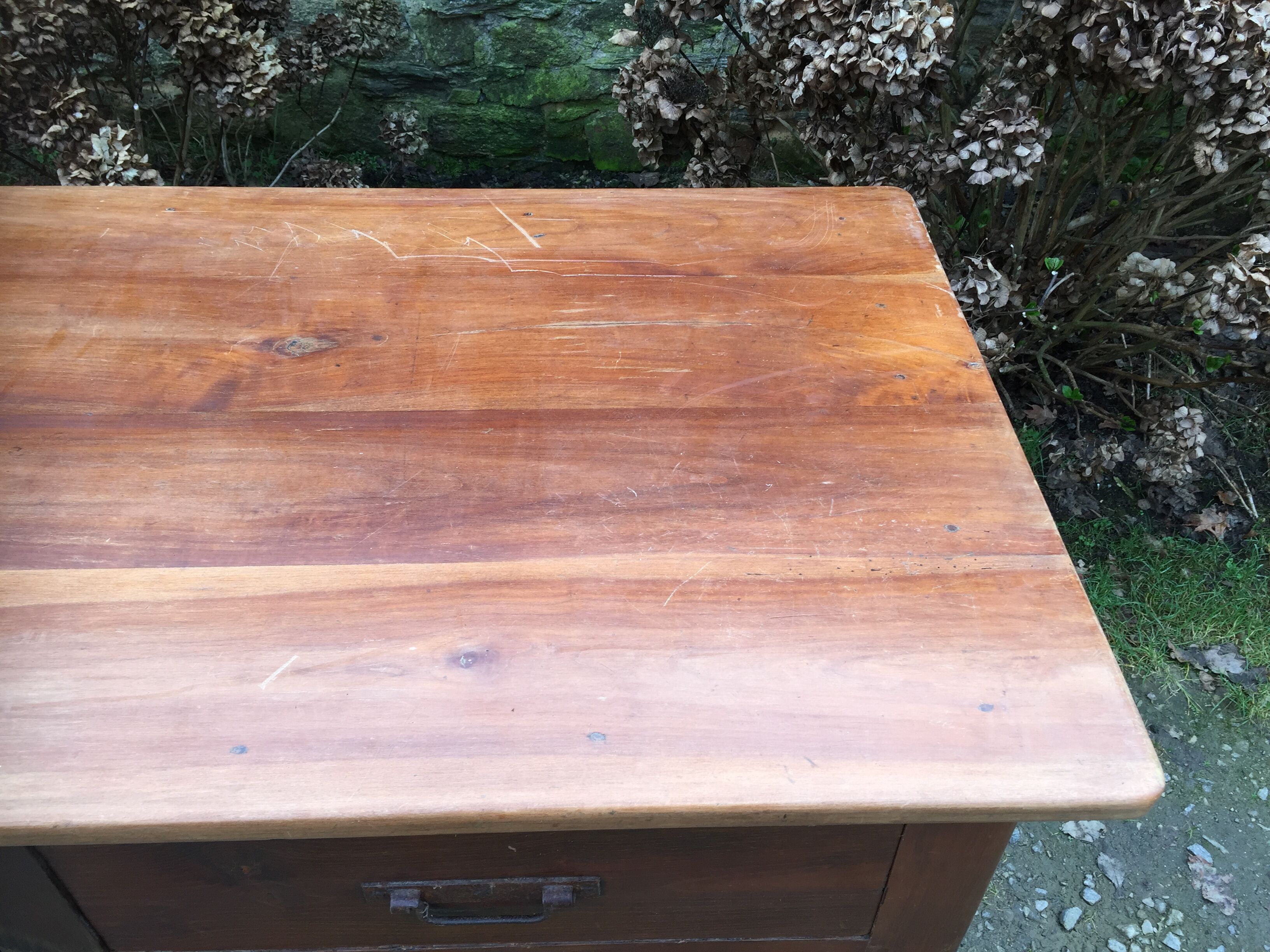 Old farmhouse table with cherry and chestnut panels with 3 drawers.