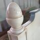 White headboard in Napoleon style with brass feet.