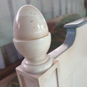White headboard in Napoleon style with brass feet.