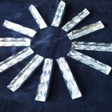 Set of 12 lead crystal knife rests in a triangular shape.