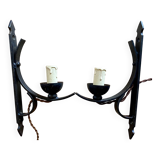 Two wrought iron wall lights, fabric cable.