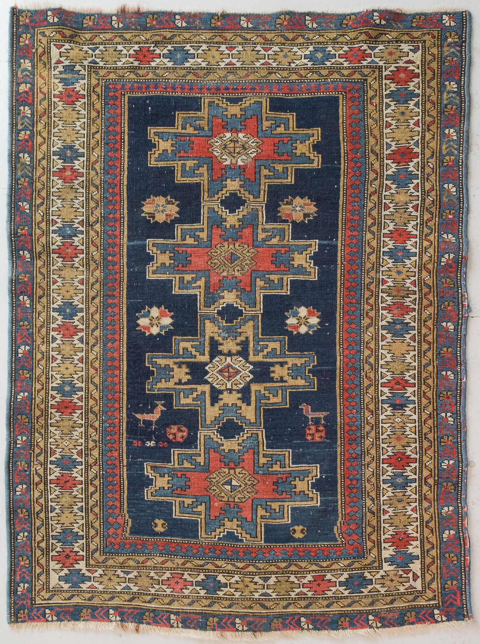 Handwoven blue ground persian rug with bird-like figures