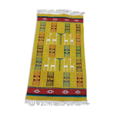 Mustard colored carpet with gazelle patterns berber style