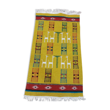 Mustard colored carpet with gazelle patterns berber style
