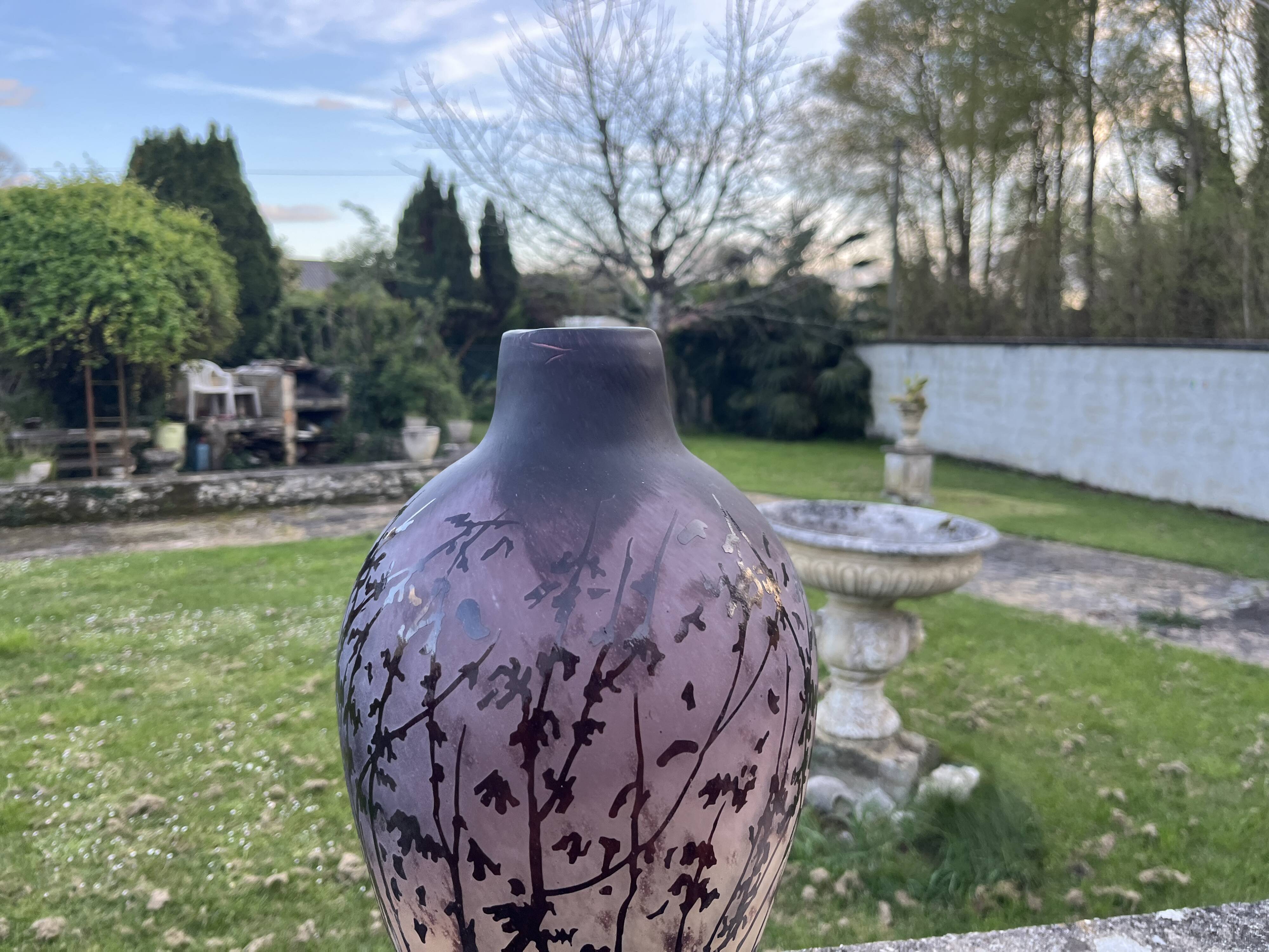 Acid-etched glass vase with a branch design.