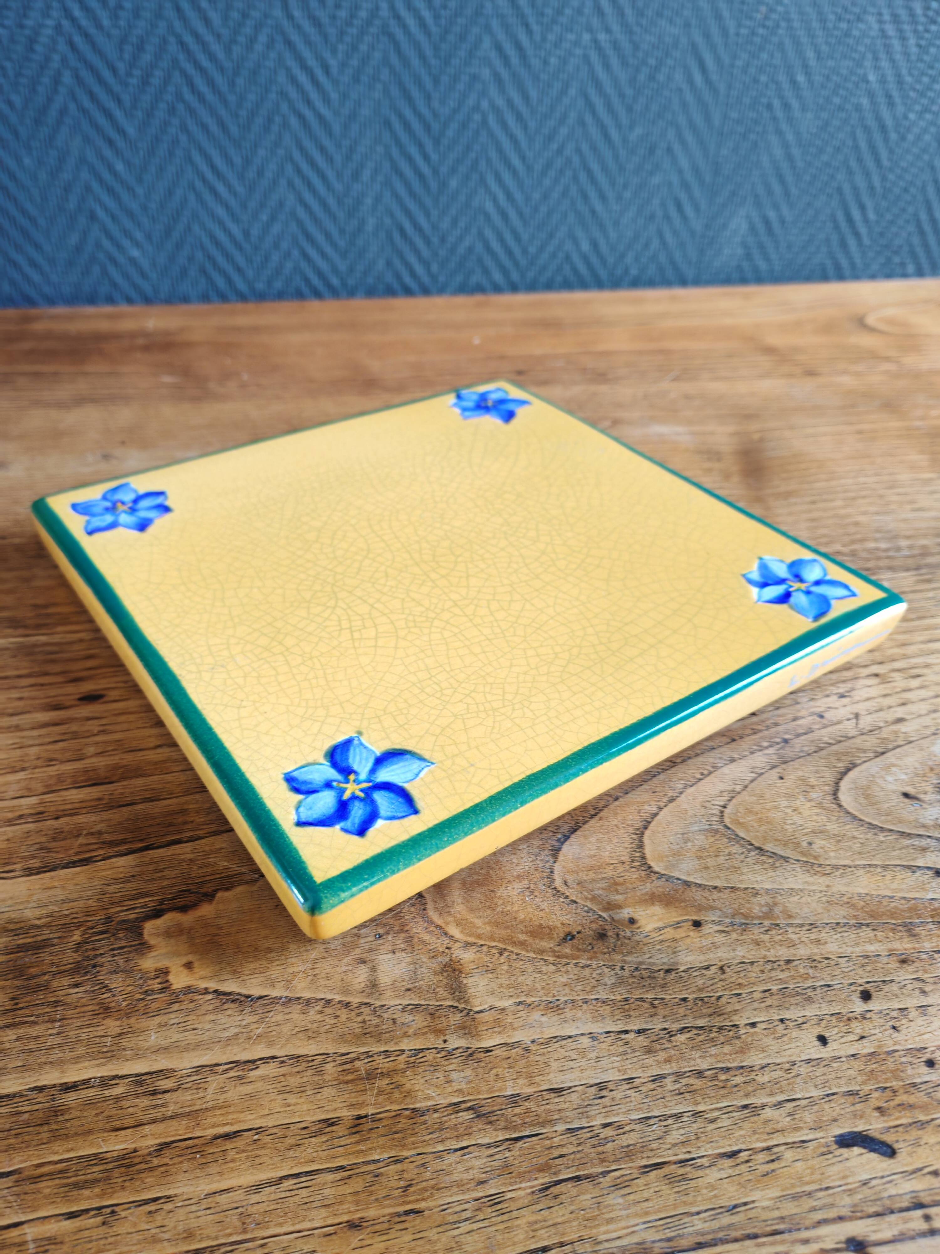 Yellow glazed ceramic trivet signed l. drimmer