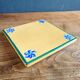 Yellow glazed ceramic trivet signed l. drimmer