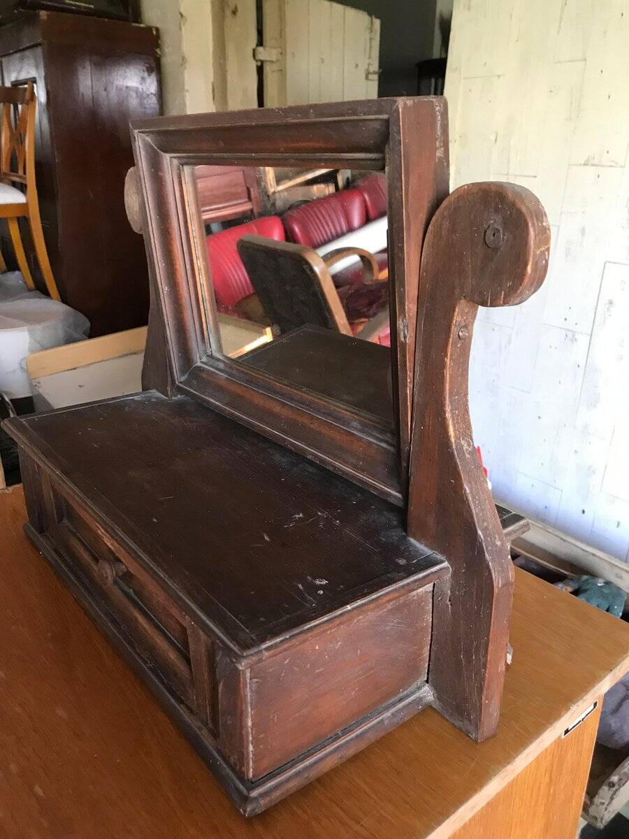 Rustic brown pine mirror, 1920s German style with decorative drawer casing.