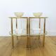 Pairs of gilded metal bedside tables and glass tops