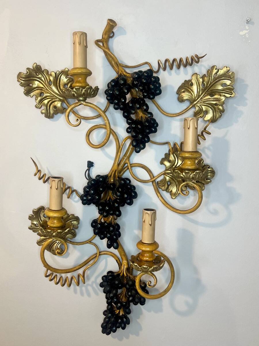 Large pair of wall sconces with vine decorations.
