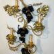 Large pair of wall sconces with vine decorations.