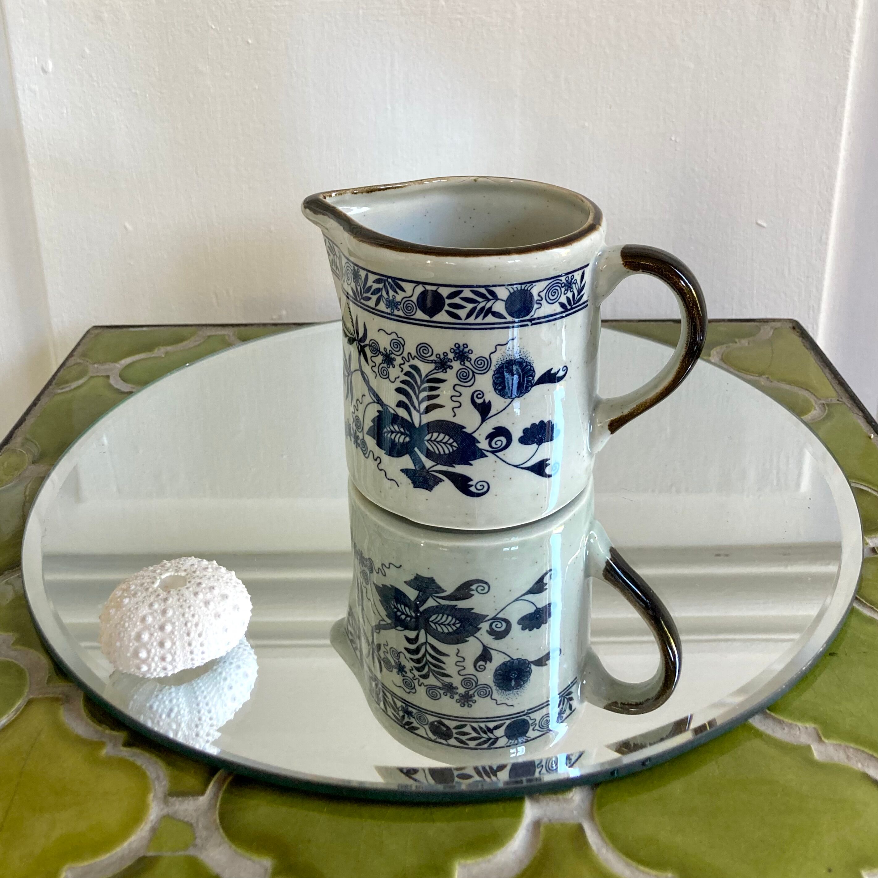 Stoneware milk jug with flower decoration